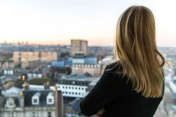 Female student watching from building