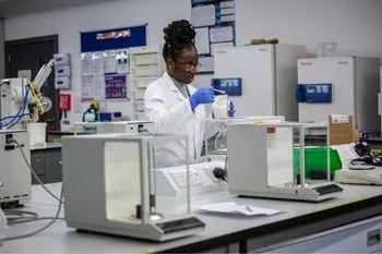 Student conductin an experiment in a college laboratory