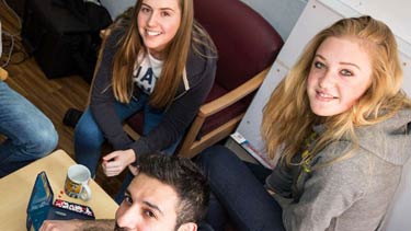 Students group smiling in front of camera