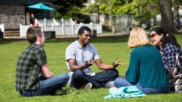 Students sitting outside in the college campus