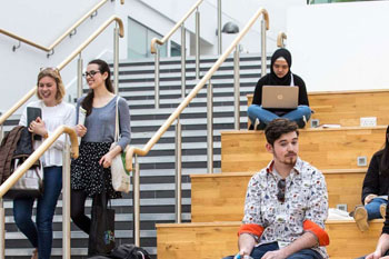 Students sitting on stairs in the college