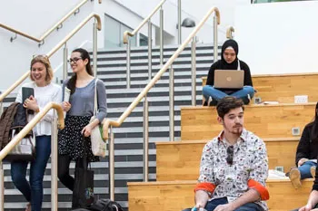 Students sitting and walking on campus