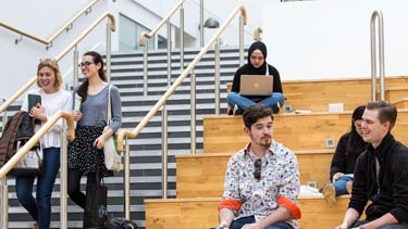 Students sitting on stairs in college campus