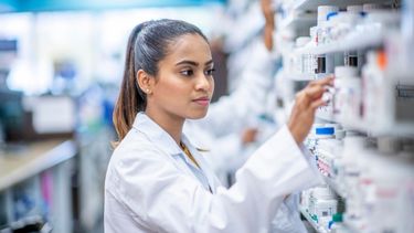 Female Student Doing Experiment In Laboratory