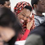 A student smiling while she learns English language.