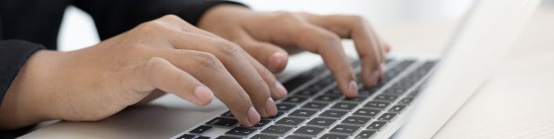 Person typing on a keyboard