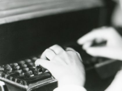 Black and white photograph of person typing