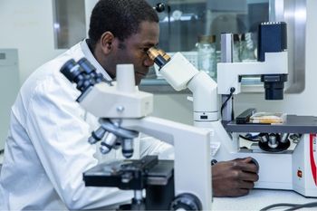 Single male clinical researcher working in a laboratory.