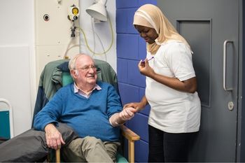 Single female healthcare assistant checking in on her patient.