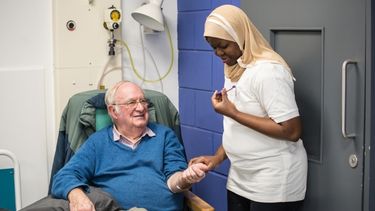 Single female healthcare assistant checking in on her patient.