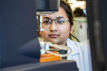 A single female pharmacist working in a laboratory.