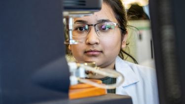 A single female pharmacist working in a laboratory.