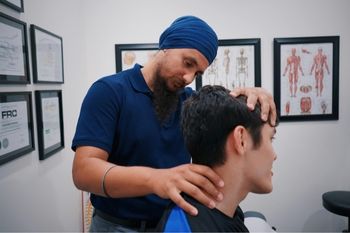 A male physiotherapist working with a patient.