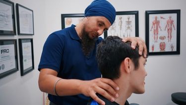 A male physiotherapist working with a patient.