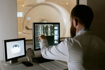 Single male radiographer reviewing an x-ray imaging.