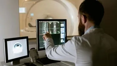 Male radiographer reviewing an x-ray imaging